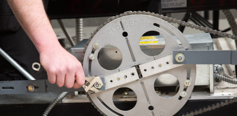 An up-close look at an elevator mechanic performing maintenance on part of an elevator.