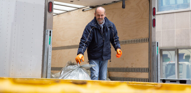 A member of the recycling and waste reduction team sorts recycling.