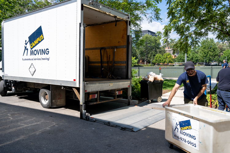 Campus movers loading a moving truck on campus